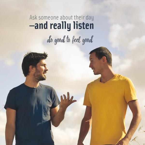 Two young men talk outside. The text reads "Ask someone about their day - and really listen. Do good to feel good."