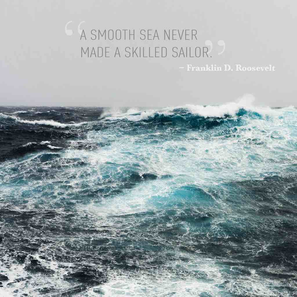 Rough and white-capping waves on the open ocean. The text above reads "A smooth sea never made a skilled sailor" and is attributed to Franklin D. Roosevelt