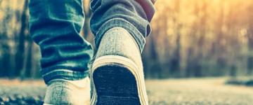 Close up of shoes of someone who is walking along path