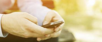 Close up photo of someone's hands using a phone
