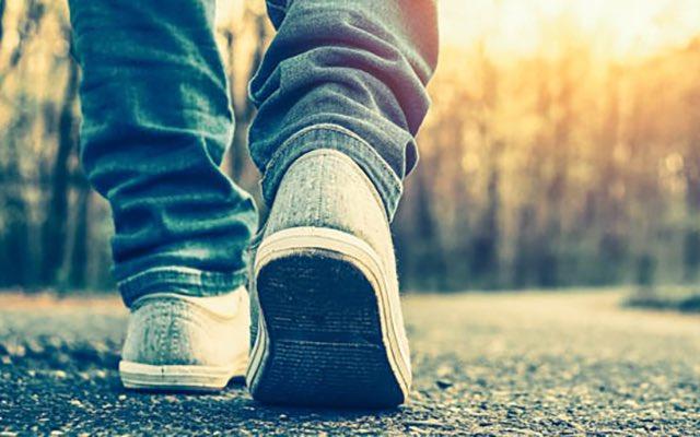Close up of shoes of someone who is walking along path