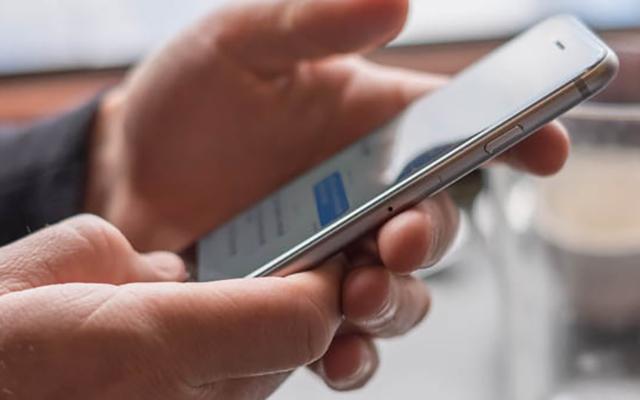 Close up of hands holding smartphone