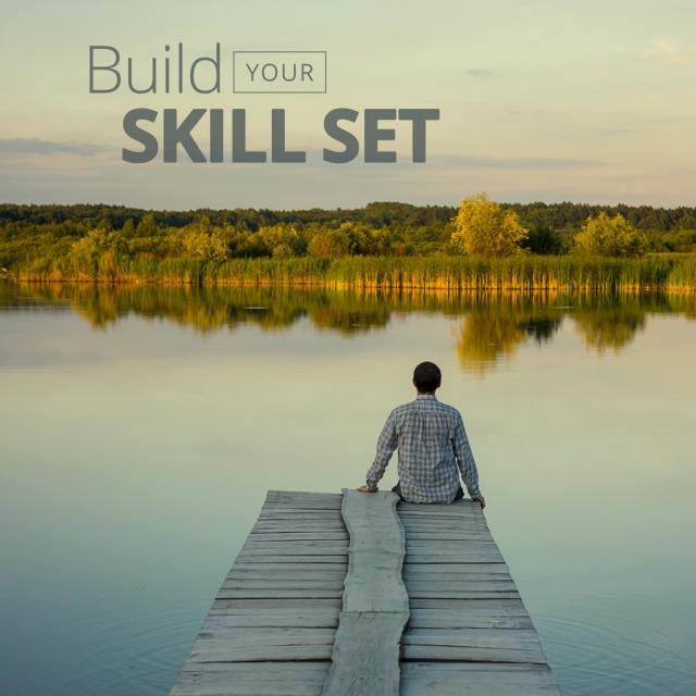 Man sitting on dock looking at lake with text saying "build your skill set"